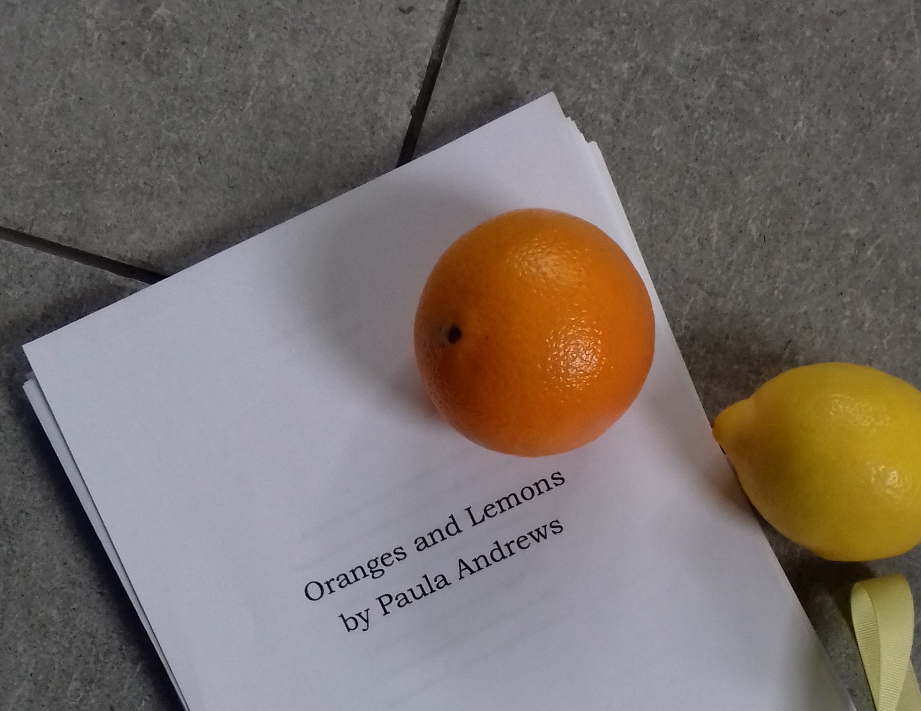 image of manuscript for Oranges and Lemons with an orange and a lemon on top
