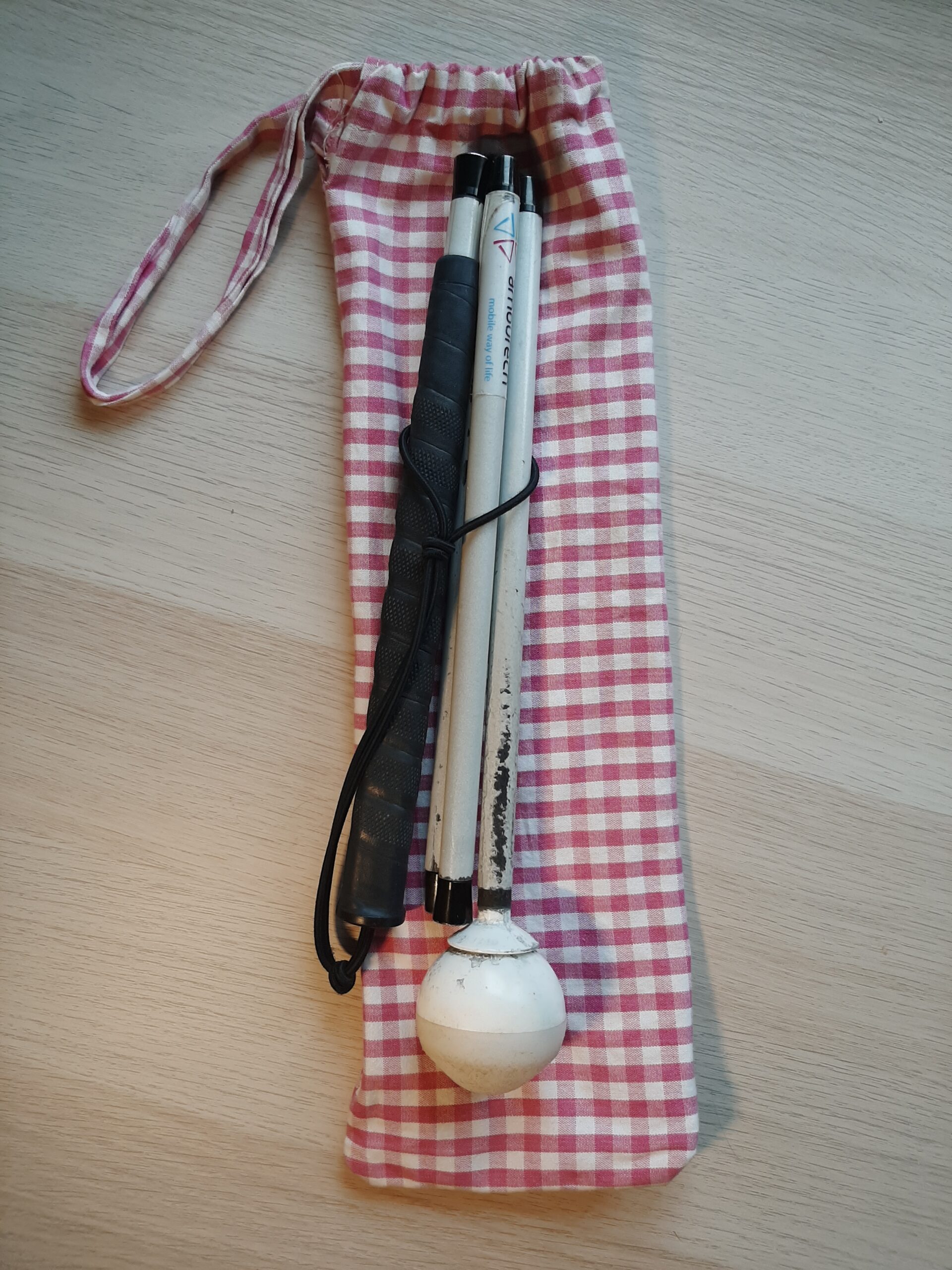 long mobility cane with pouch made from red gingham fabric